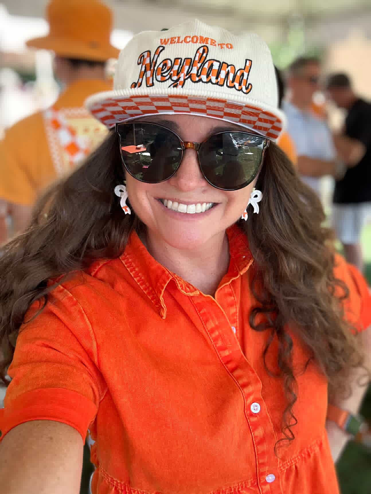 Sweet Tree handcrafted clay earrings in Tennessee orange and white